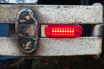The brilliant Brake & Run light mounted in a rusty bumper.